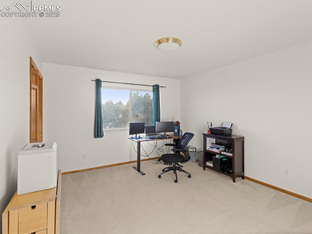 Image 22 of 49: Office space featuring light carpet and baseboards
