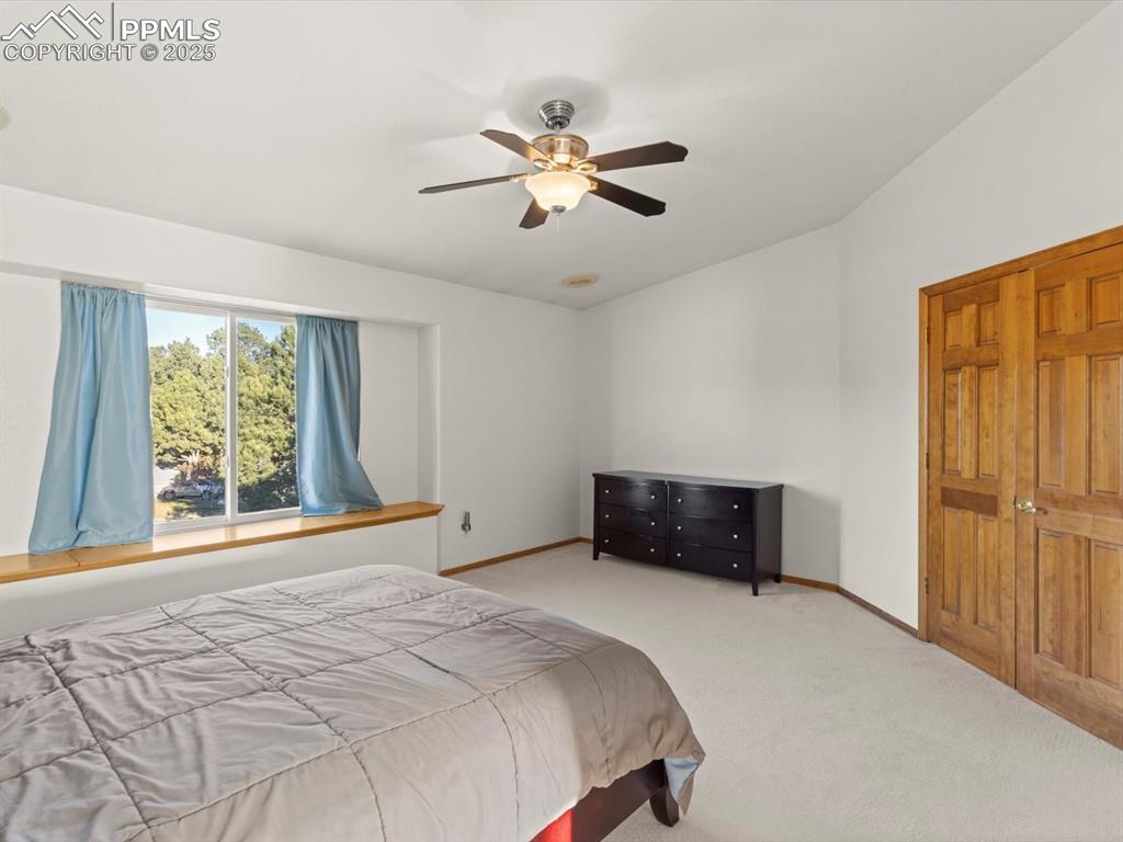 Image 24 of 49: Bedroom with carpet flooring and ceiling fan