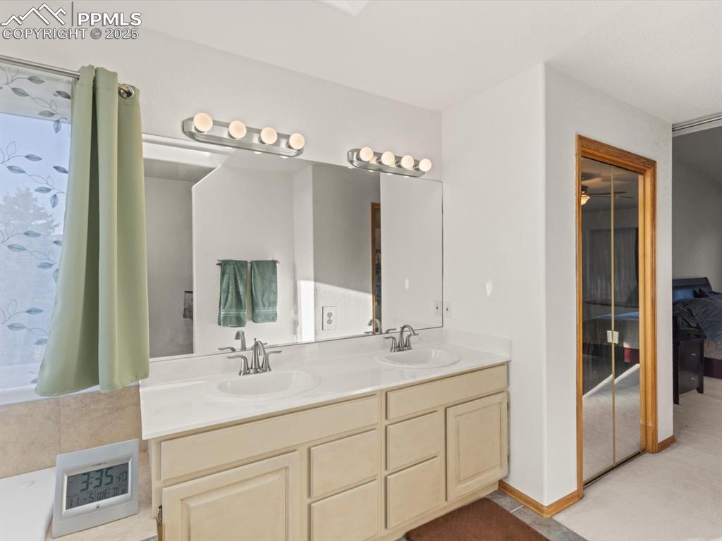 Image 26 of 49: Bathroom featuring double vanity and baseboards