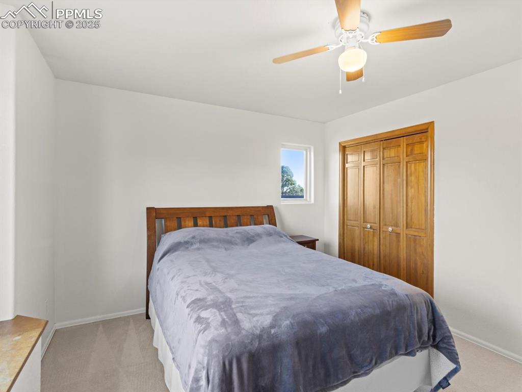 Image 30 of 49: Bedroom featuring light colored carpet, a closet, and ceiling fan