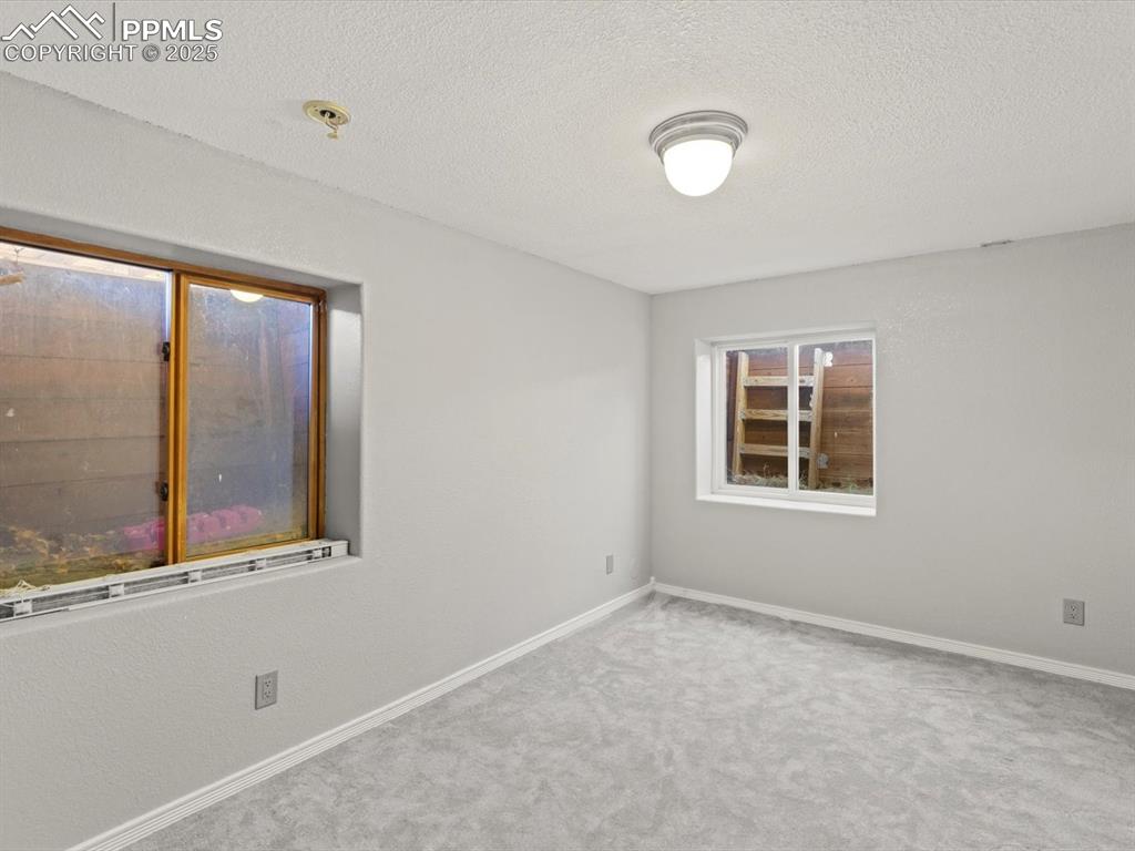Image 35 of 49: Spare room with a textured ceiling and carpet floors