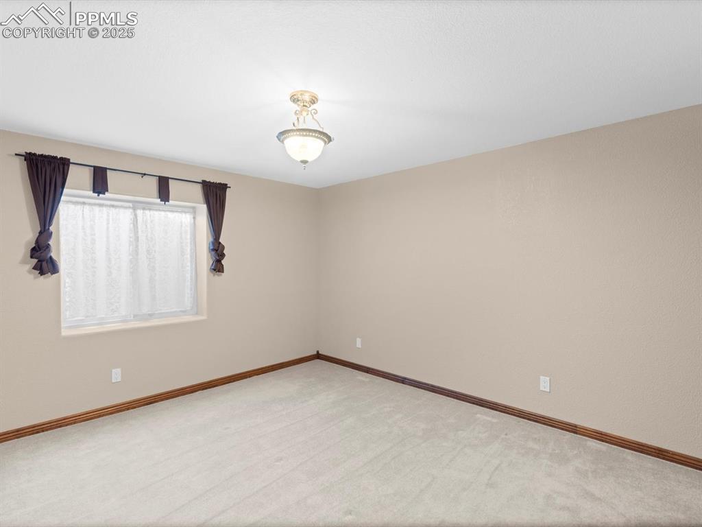Image 36 of 49: Carpeted spare room with baseboards
