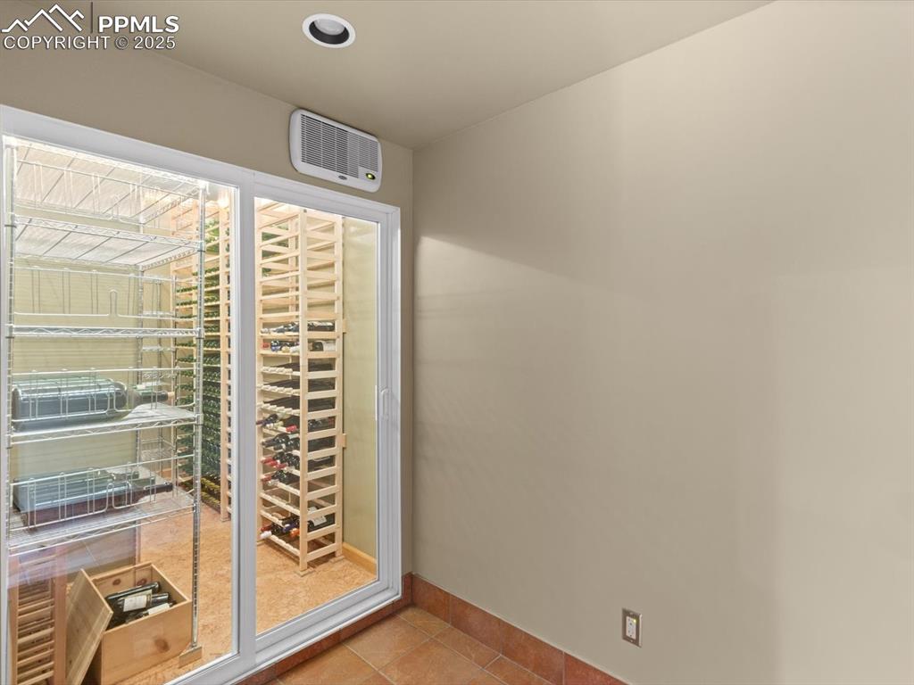 Image 39 of 49: Wine area featuring light tile patterned floors and baseboards