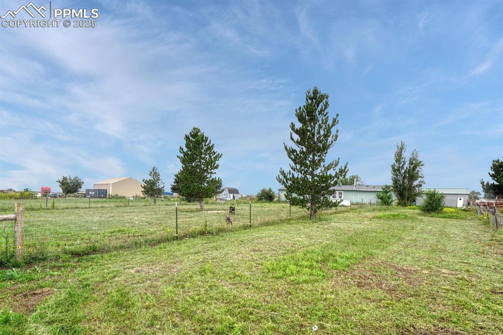 Image 29 of 38: View of backyard that is fenced in zones for all your needs. Horses, cattle