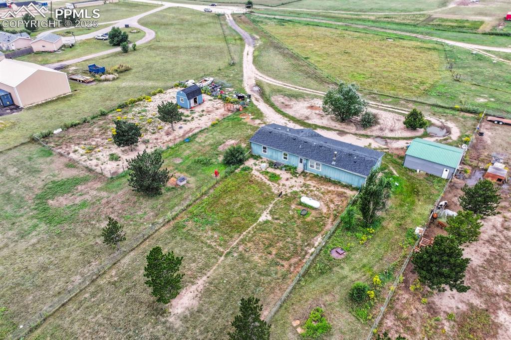 Image 33 of 38: Aerial view of property showing 1 of 2 tuff shed, house and garage. 