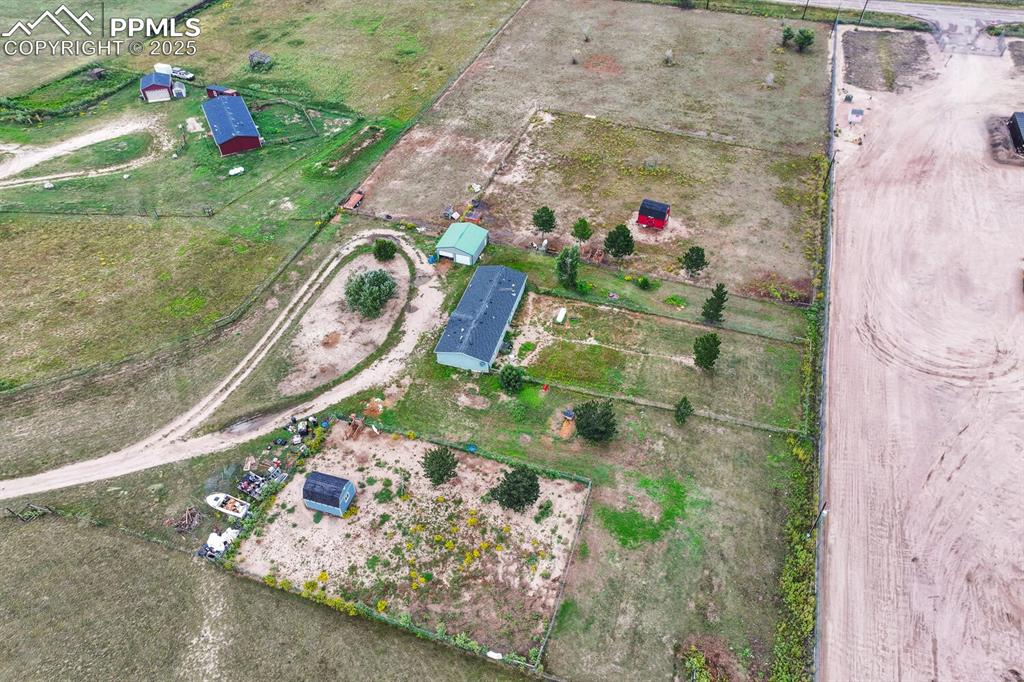 Image 38 of 38: View of property location featuring garage and two tuff sheds plenty of spa