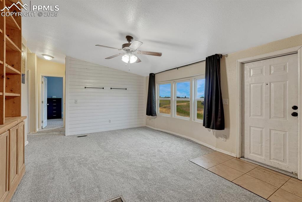 Image 5 of 38: View of living room from entrance of home. Featuring brand new carpet, ship