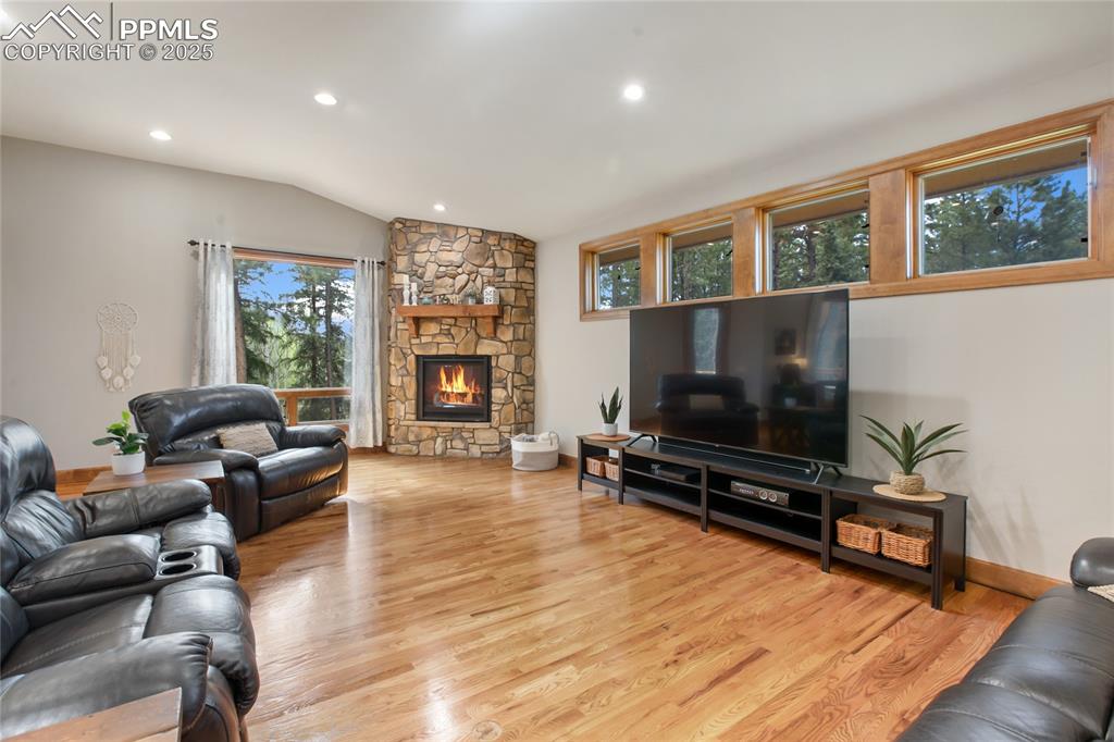 Image 13 of 49: Open concept living room with gas fireplace on main level
