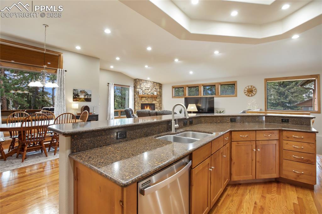 Image 14 of 49: Open concept kitchen with granite covered island on main level