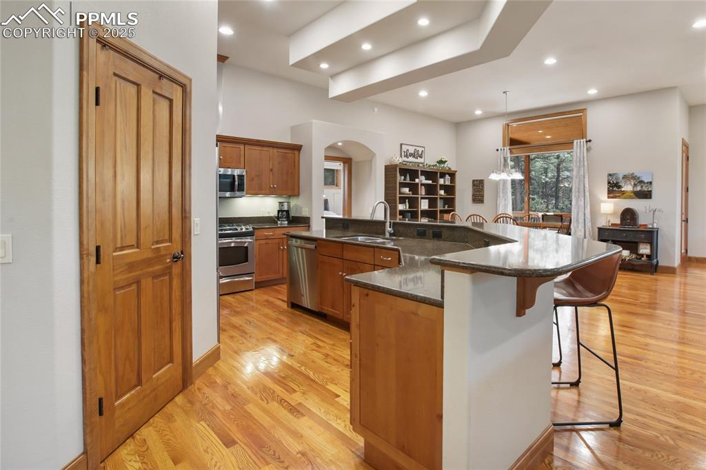 Image 19 of 49: Kitchen island and pantry on main level