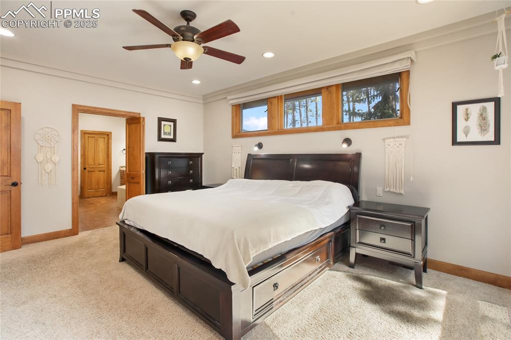 Image 20 of 49: Primary bedroom on main level with walk out to deck