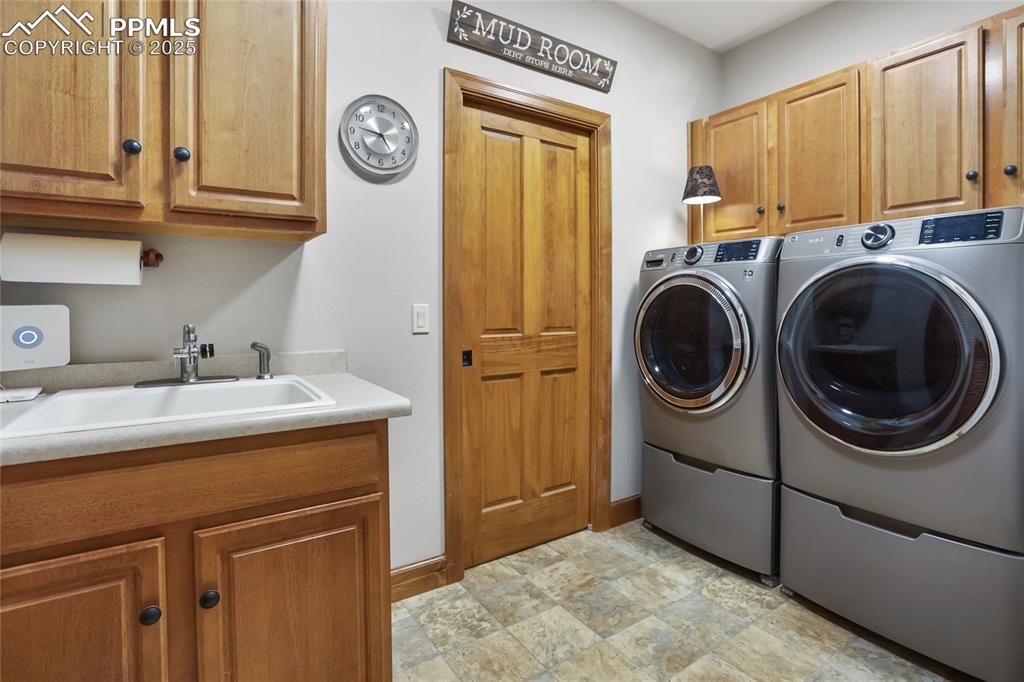 Image 26 of 49: Main level laundry with access to primary closet