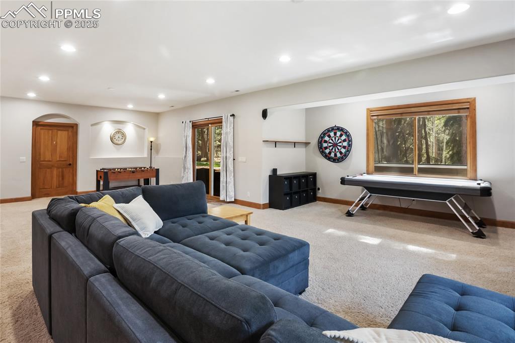 Image 32 of 49: Basement level family room with walk out to backyard