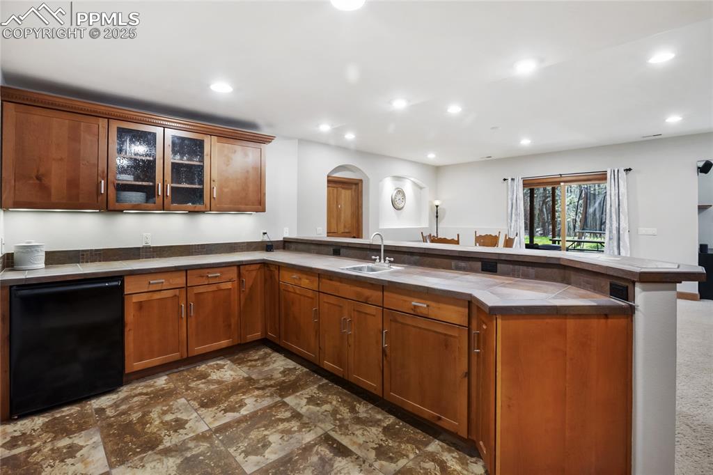 Image 36 of 49: Wet bar in basement family room