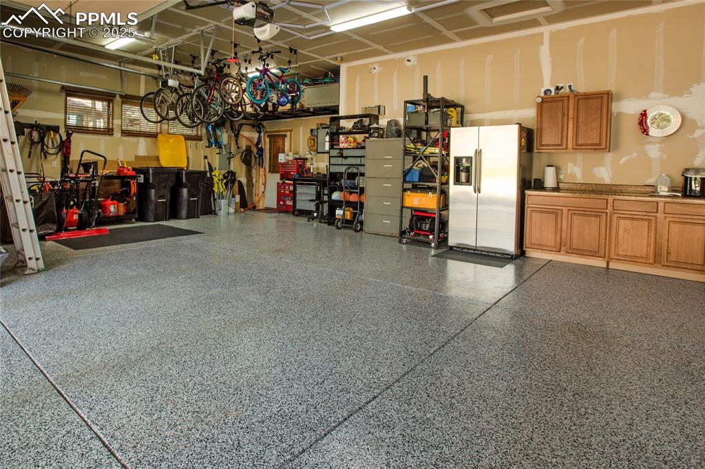 Image 44 of 49: 3 car garage with epoxied floors