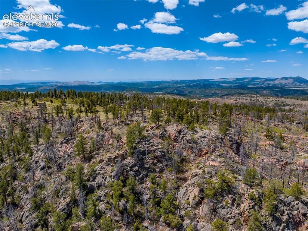 Image 10 of 50: Aerial from NE to driveway and cabin