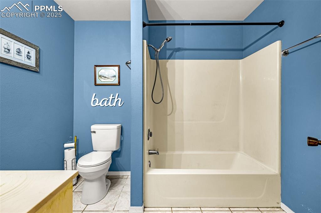 Image 14 of 42: Full bathroom featuring vanity, light tile patterned floors, and washtub / 