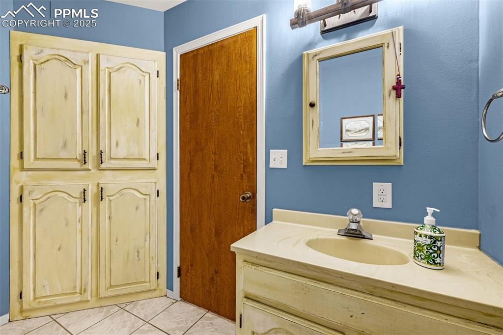 Image 15 of 42: Bathroom with vanity and light tile patterned floors