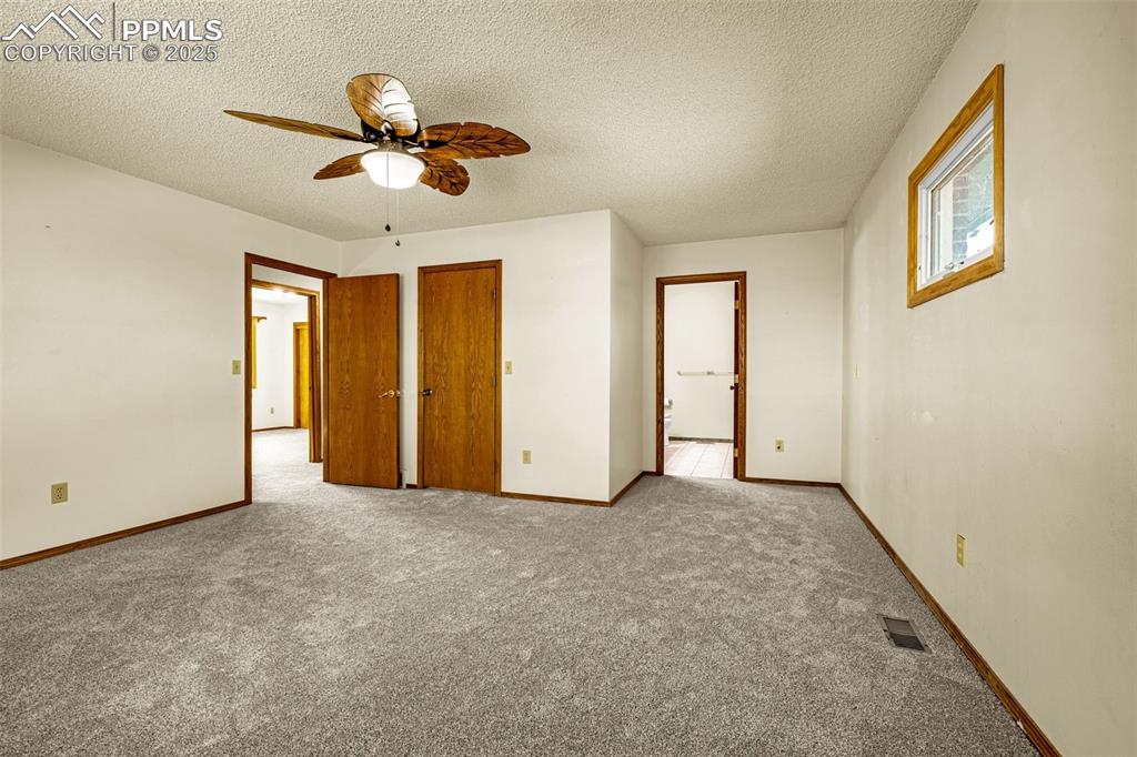 Image 19 of 42: Unfurnished bedroom featuring a textured ceiling, carpet flooring, and a ce