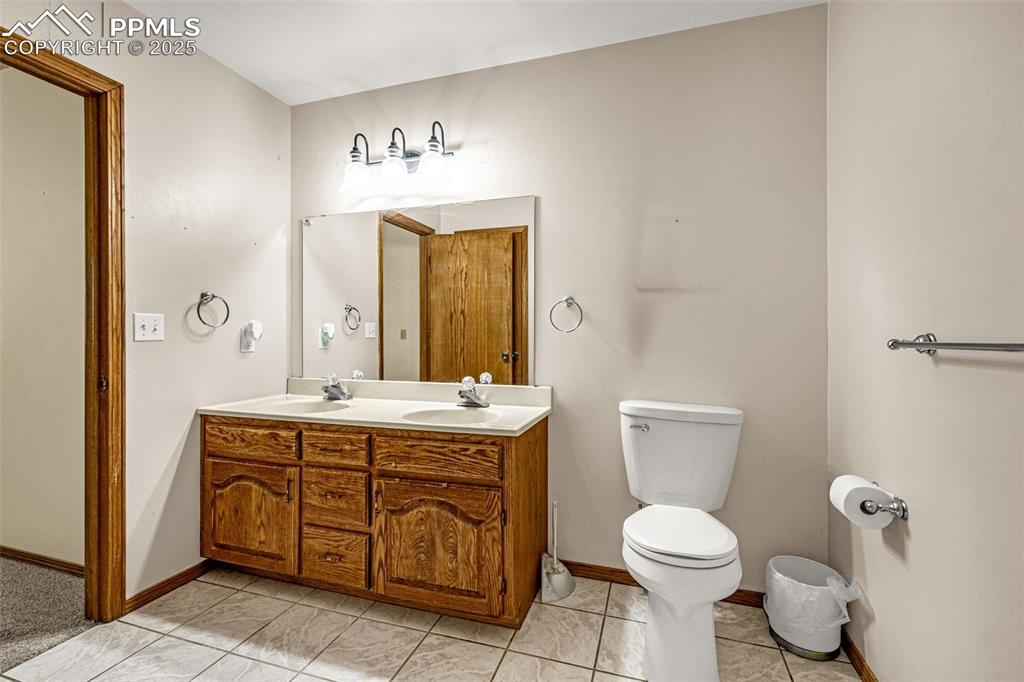 Image 21 of 42: Full bathroom featuring double vanity and light tile patterned floors