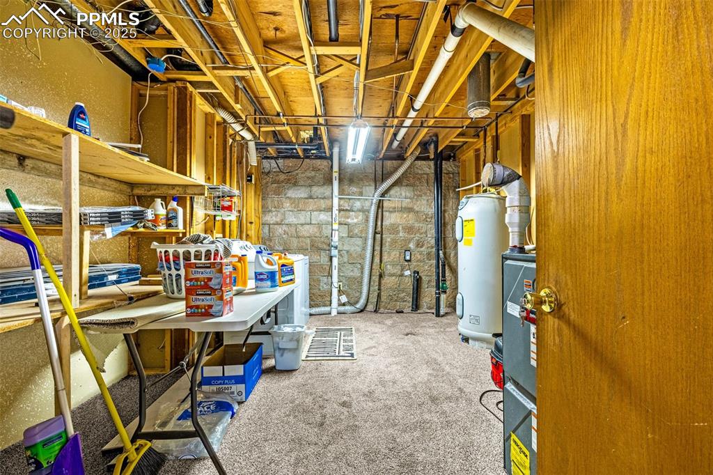 Image 29 of 42: Unfinished below grade area featuring electric water heater and light color