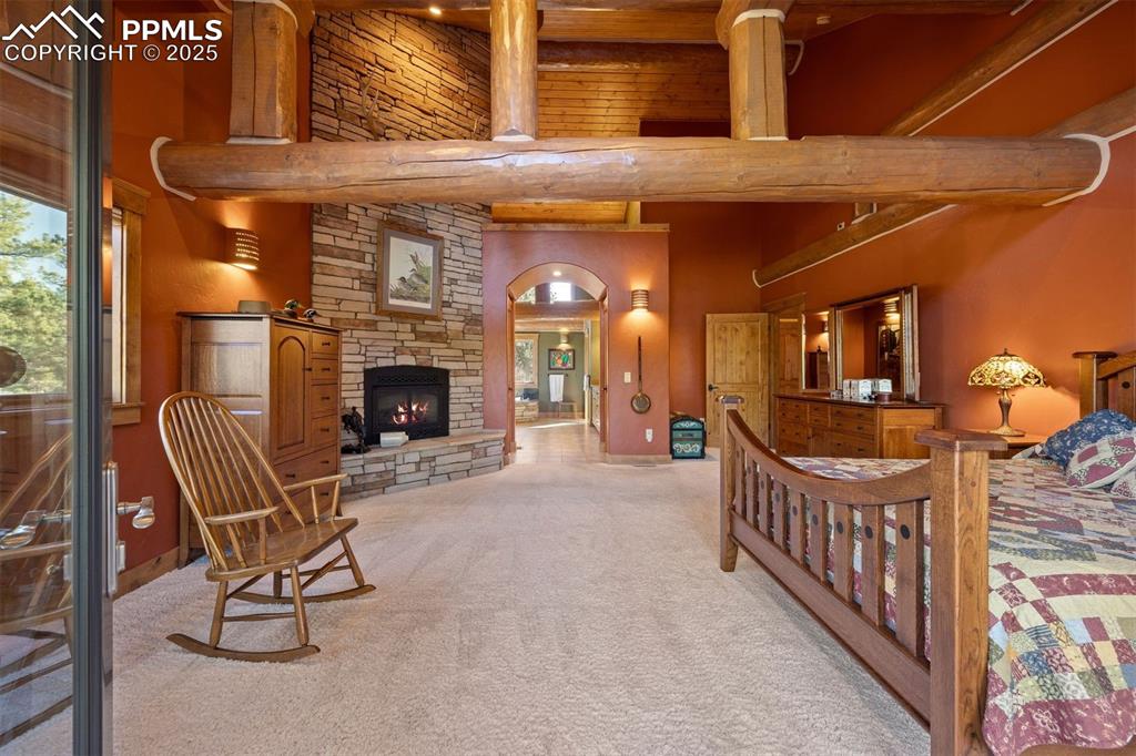 Image 12 of 41: Spacious bedroom accommodating sitting areas and warmed by a fireplace. 