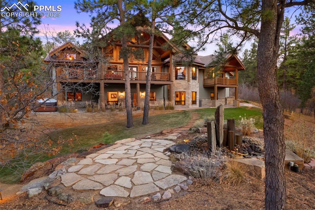 Image 33 of 41: Expansive decks, stone patios, and forest surrounds create a true Colorado 