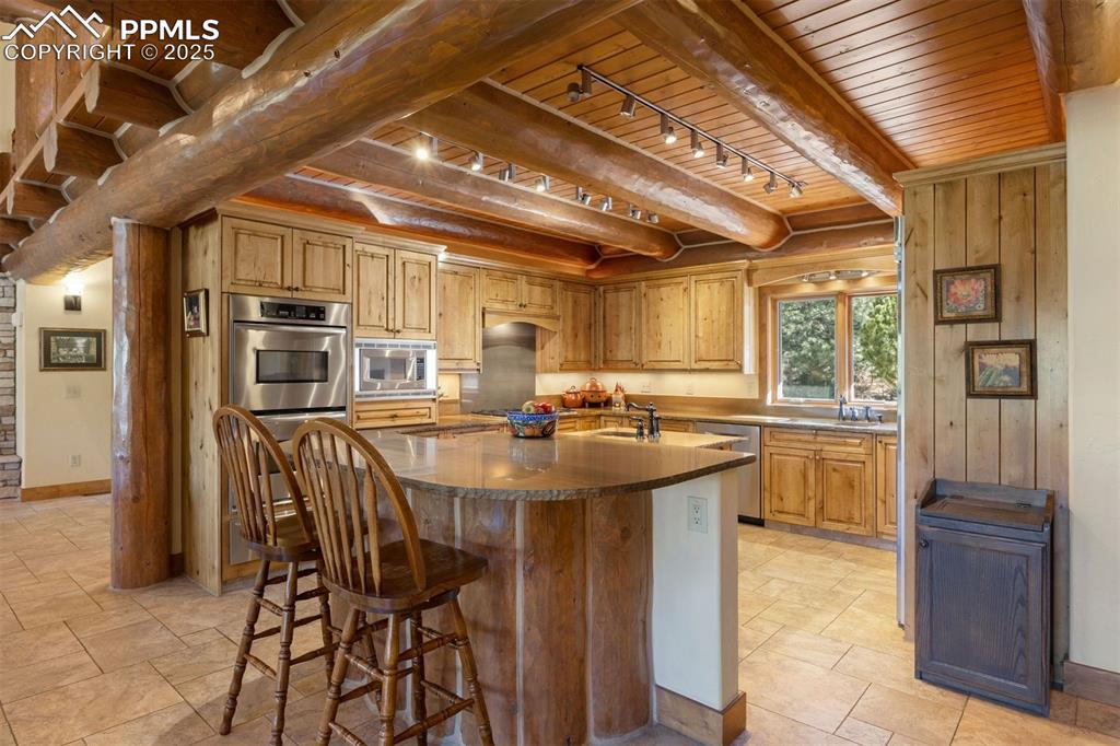 Image 8 of 41: Double ovens, a warming drawer, gas cooktop, and Bosch dishwasher make ever