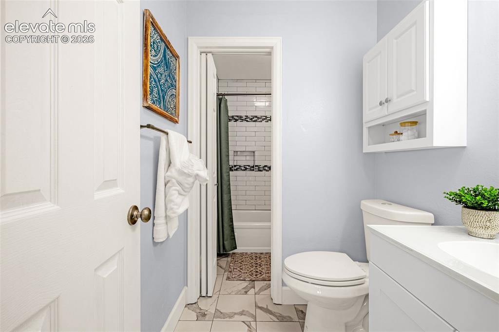 Image 11 of 44: Bright room with neutral wall color and grey carpet flooring