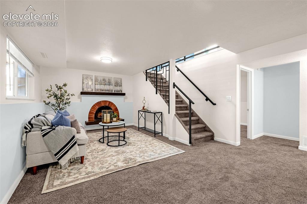 Image 16 of 44: Carpeted upper-level bedroom featuring a ceiling fan with integrated lighti