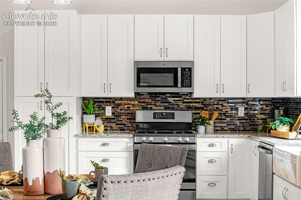 Image 22 of 44: Spacious interior featuring wood-finish flooring, vaulted ceilings, and con
