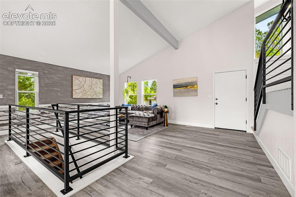 Image 23 of 44: Kitchen featuring white shaker-style cabinetry, granite countertops, and a 
