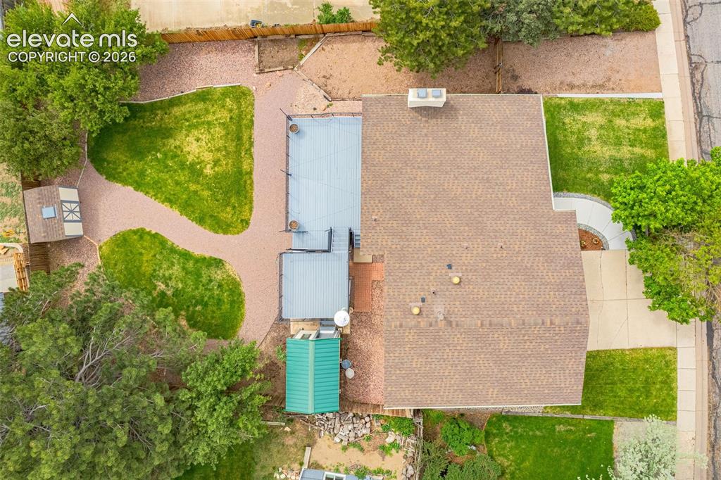 Image 34 of 44: Split-level residence featuring a two-car garage, light-toned siding with d