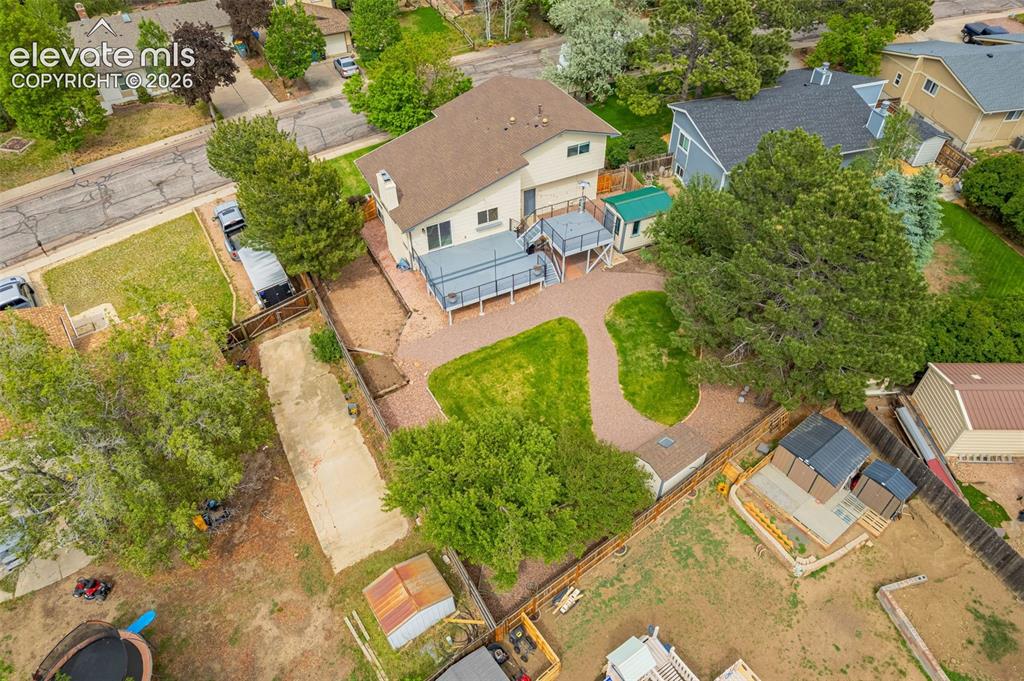 Image 35 of 44: Overhead perspective highlighting the shingle roof, paved driveway, and est
