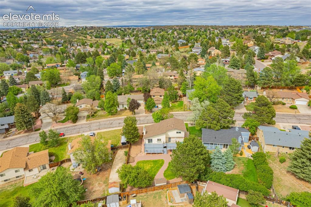 Image 37 of 44: Expansive aerial perspective showcasing a verdant neighborhood with varied 