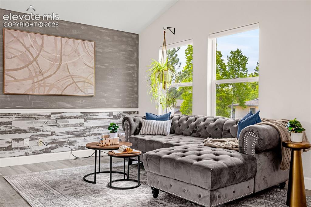 Image 7 of 44: Arched fireplace with white brick surround, distressed wood-finish accent w