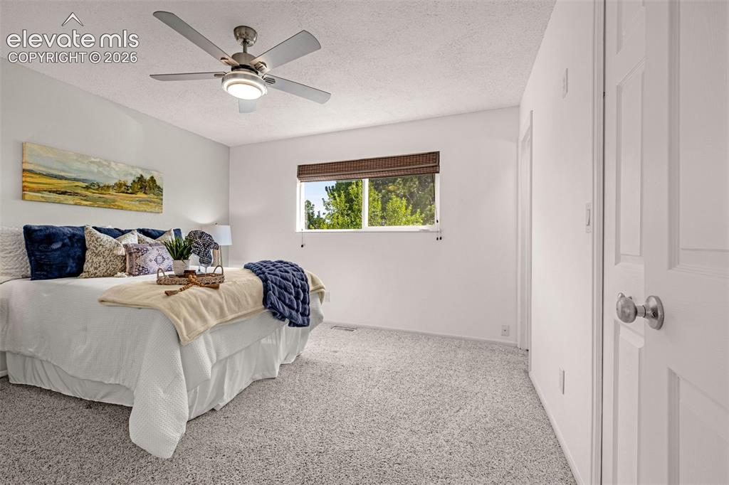 Image 8 of 44: Living area featuring a vaulted ceiling and two large front windows