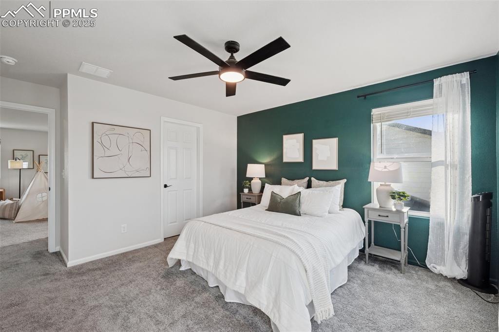 Image 17 of 30: Bedroom with carpet flooring and ceiling fan