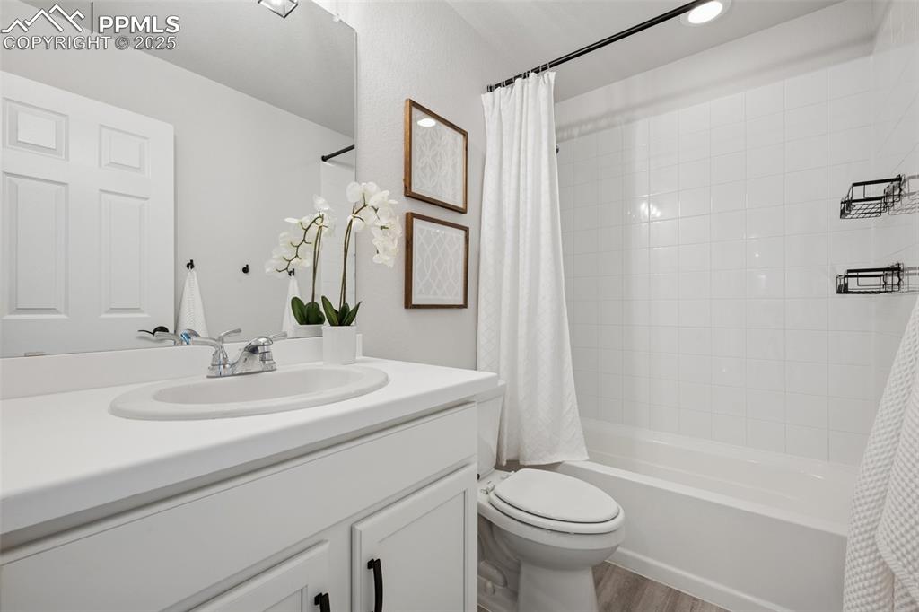 Image 22 of 30: Full bath featuring vanity, shower / bath combo with shower curtain, and wo