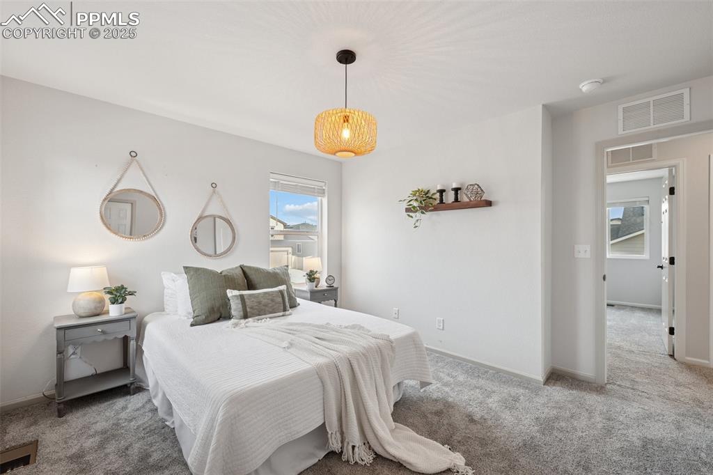 Image 24 of 30: Carpeted bedroom with baseboards