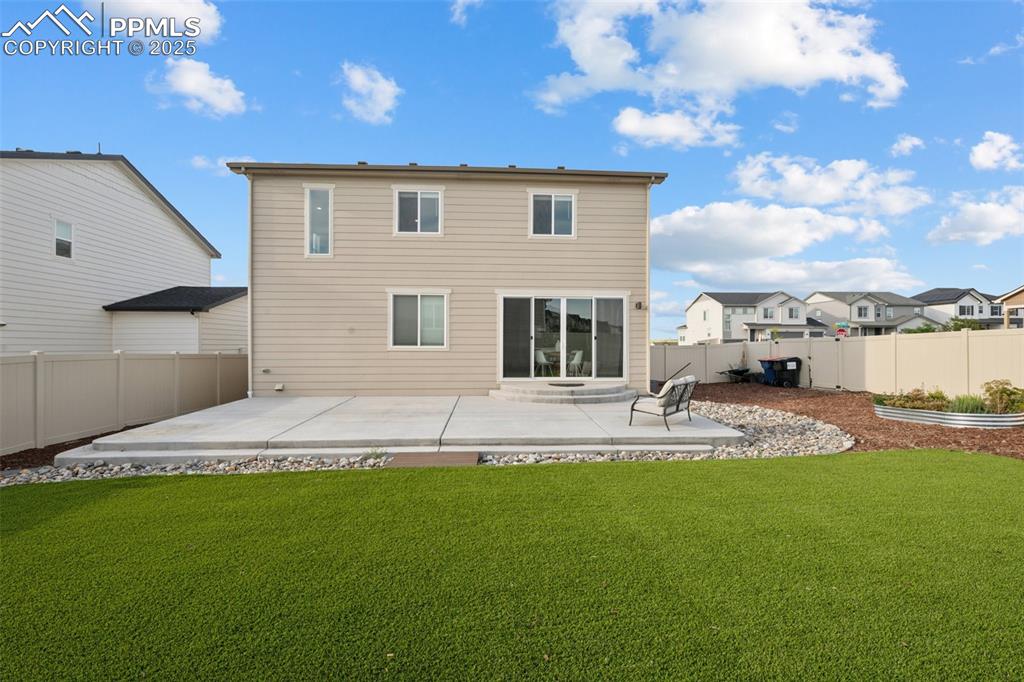Image 25 of 30: Back of property featuring a patio, turf and a fenced backyard