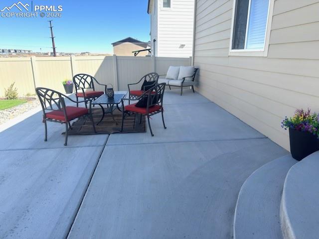 Image 32 of 34: Spacious entertaining space in landscaped backyard