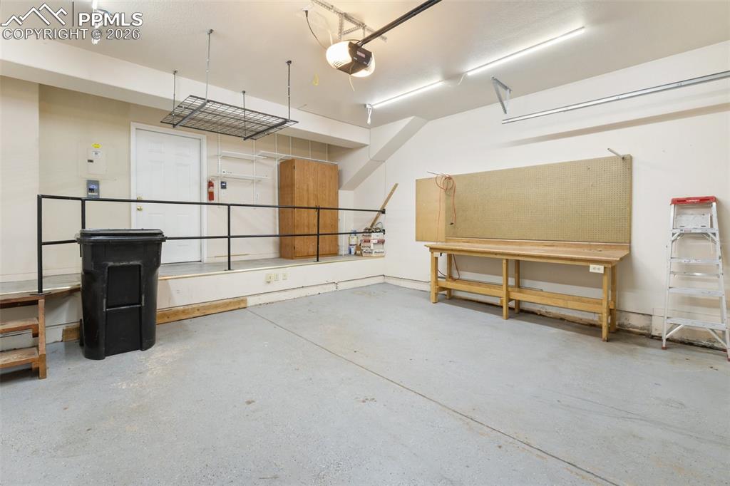 Image 15 of 36: Garage featuring a garage door opener