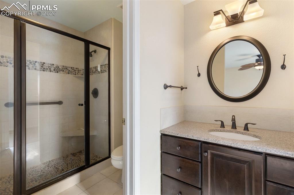 Image 18 of 36: Bathroom featuring a stall shower, vanity, and light tile patterned floors