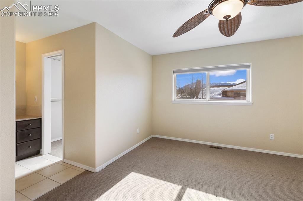 Image 20 of 36: Unfurnished room with light colored carpet and a ceiling fan