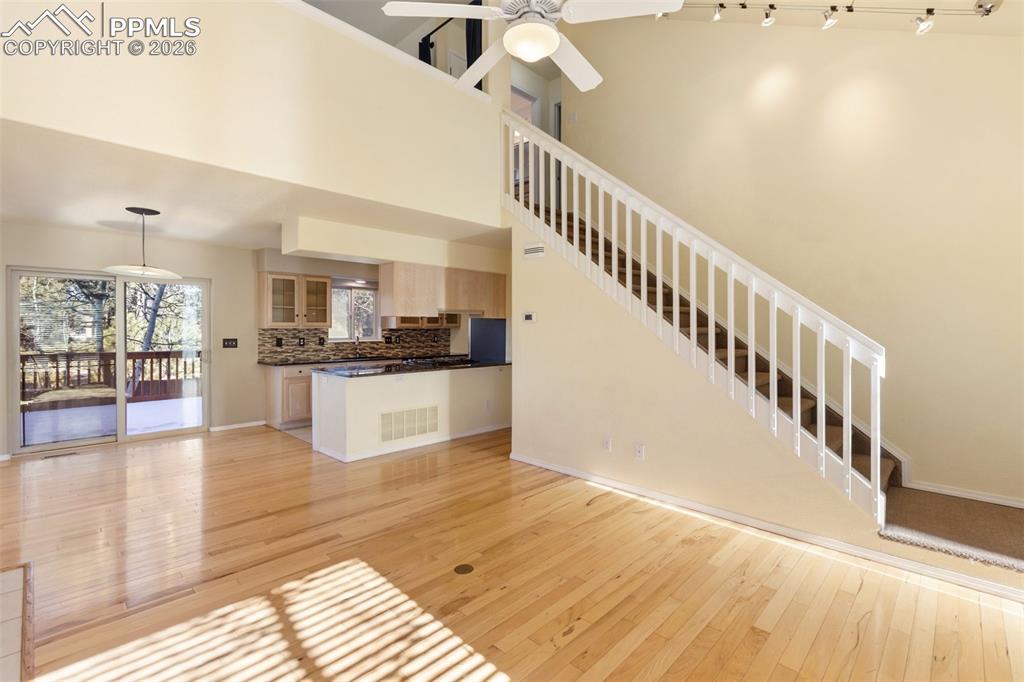 Image 3 of 36: Unfurnished living room featuring light wood-style floors, ceiling fan, a h