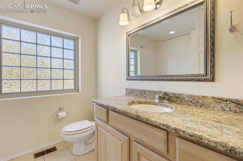 Image 31 of 36: Full bathroom featuring vanity, light tile patterned flooring, plenty of na