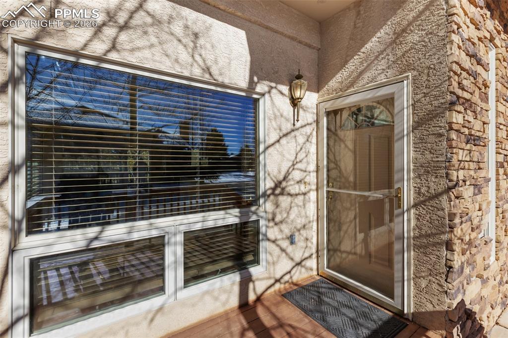 Image 36 of 36: Doorway to property featuring stucco siding