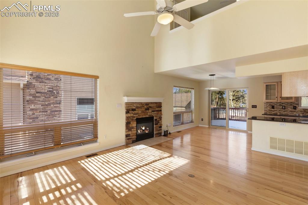 Image 4 of 36: Unfurnished living room with a fireplace, light wood-style floors, ceiling