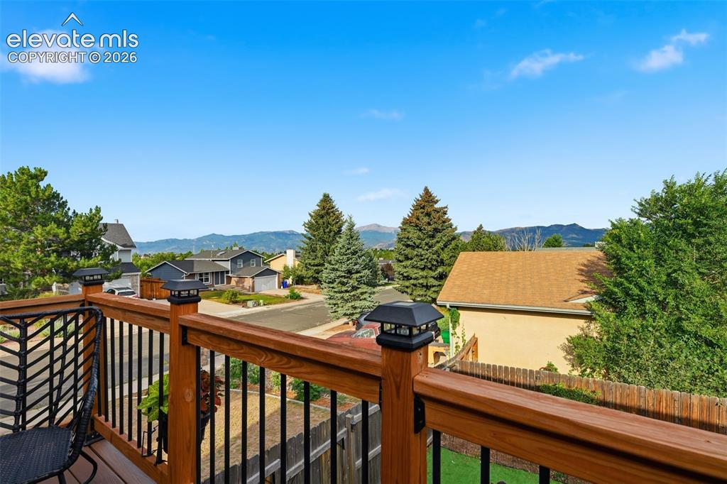Image 12 of 28: Expansive outdoor deck featuring wood newel posts, wood handrails, black me